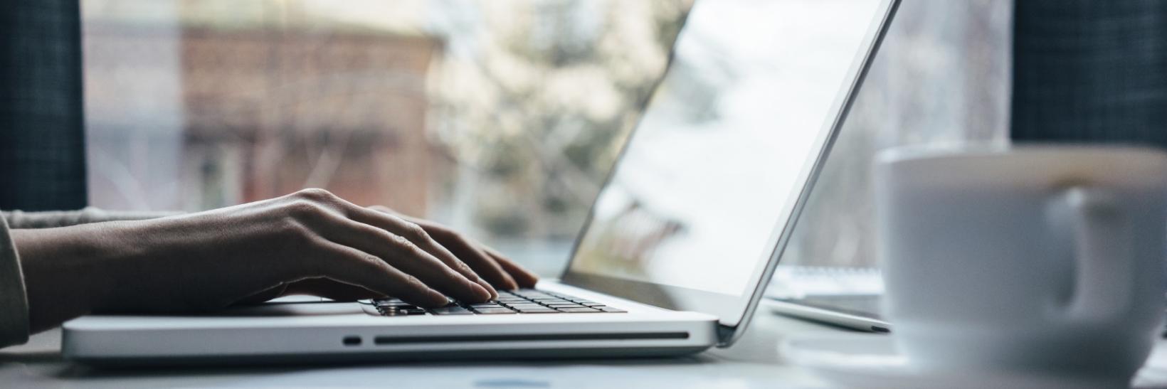Person typing on a laptop computer