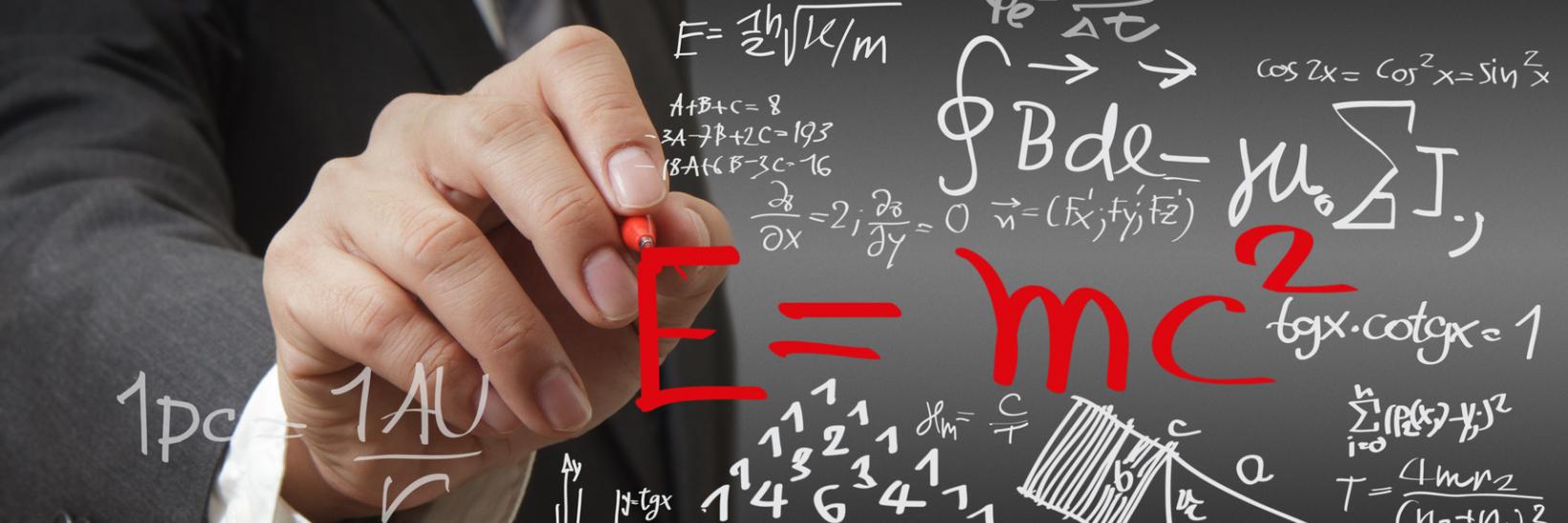 Hand writing math and science formulas. 