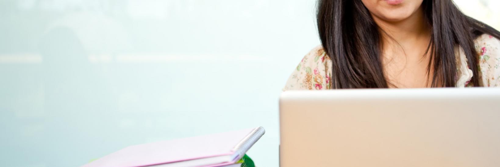 Student with laptop and books.