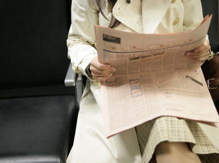 woman reading a newsletter