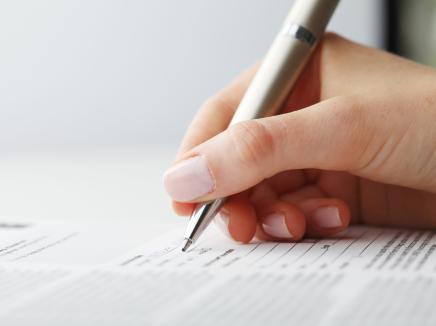 hand signing a document 