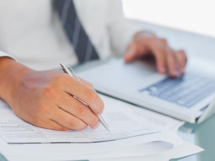 man filling out paperwork