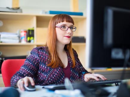 A designated school official submits her questions about the SEVP Response Center on a computer