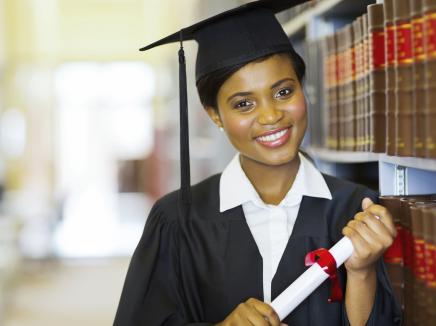 african american female student with her degree in hand