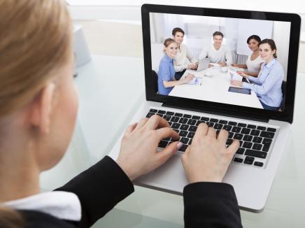 woman watching a webinar on her computer