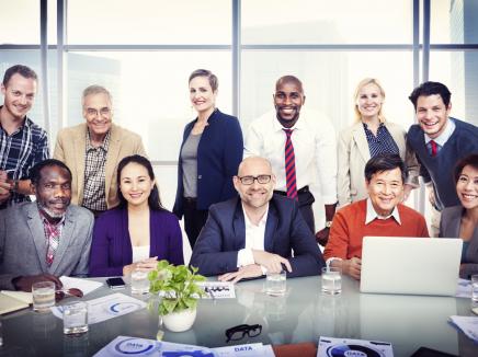 a group of business people around a conference table 