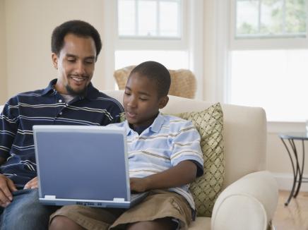 man and his son on a laptop