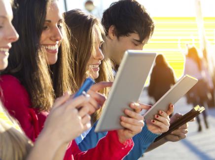 Students working on their smart phones and tablets