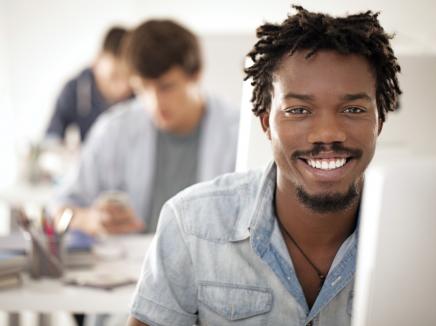 Man smiling at laptop