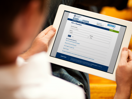Person holding a tablet with the Ask a Question tool loaded on the screen. 