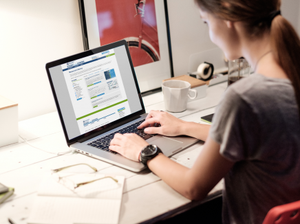 A woman visiting the Resource Library on her laptop.
