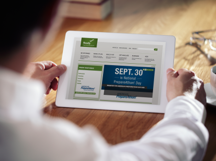 Man holding tablet with Ready.gov's homepage loaded, promoting September 30. 