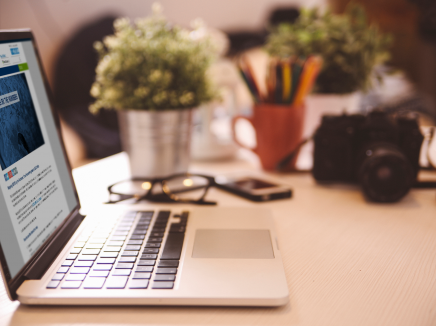 laptop on a desk with Mapping SEVIS by the Numbers on the screen. 