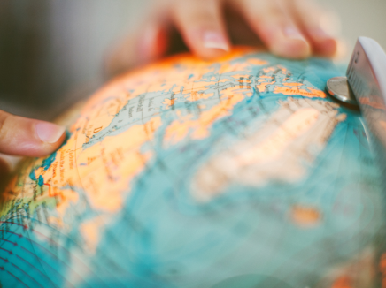 Close up of someone's hands on a globe