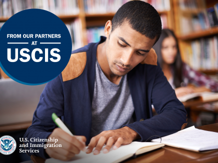 Young student writing at a desk with USCIS logo in bottom left corner.