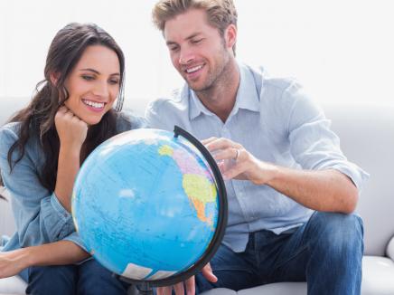 a couple looking at a globe