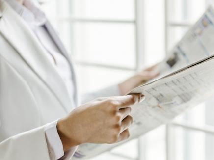 person reading a newletter