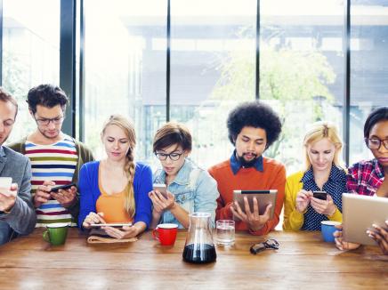 group of young adults on mobile devices