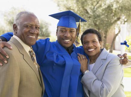 young man and his parents at graduation