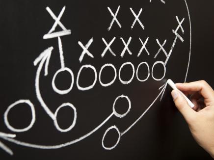 Sports strategy drawn in X's and O's on a chalkboard. 