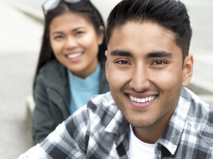 A man and woman smiling. 