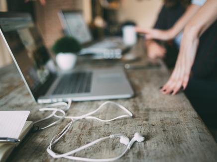 Laptops with headphones sitting on the table.