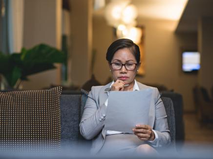 A woman reading a document.