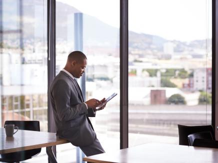 A man looking at a tablet computer.