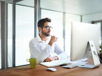 A man using a desktop computer.