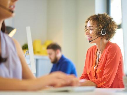 A woman wearing a telephone headset. 