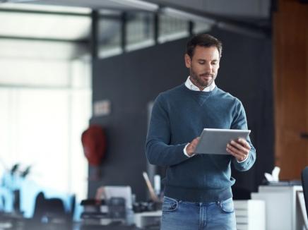 A man looking at a tablet computer.