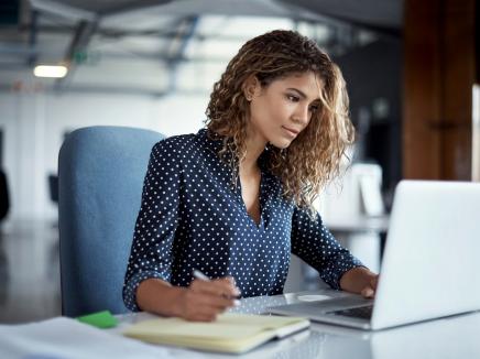 A woman working on a laptop computer.