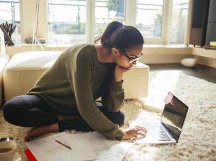 Young woman studying and working on her laptop.