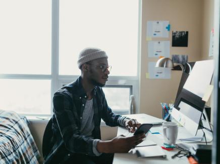 African american student working in his bedroom office