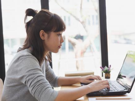 A woman working on a laptop computer.