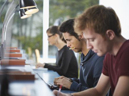three students in a library