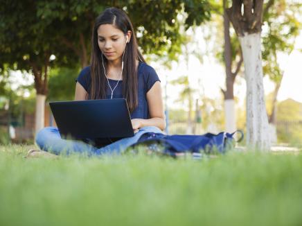 girl using a laptop outside