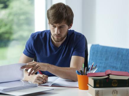 A male student studying at a desk