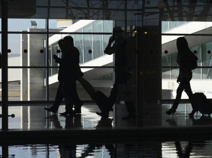 Silhouettes of travels in an airport terminal 