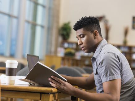 young man studying in the library. 