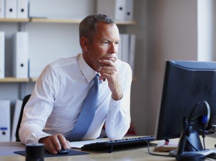 A man looking at his computer. 