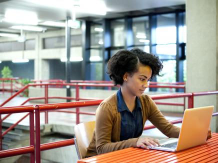 A female student using a laptop computer.