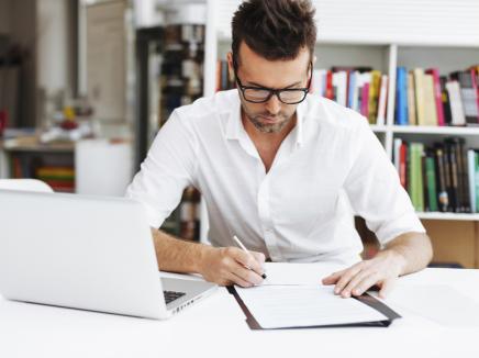 A man writing on his notepad.