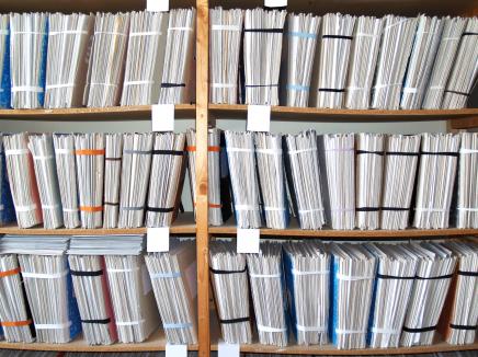 Paper files on a shelf.