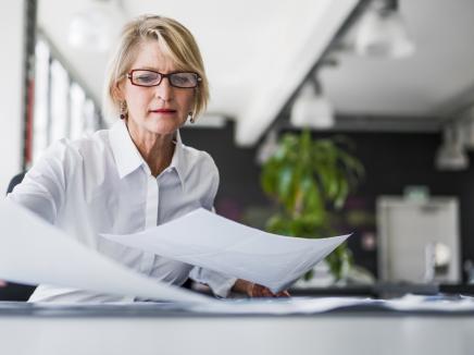 A woman examining documents.