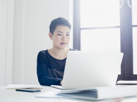 A woman working on her laptop computer.