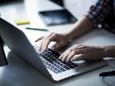 A person typing on a computer.