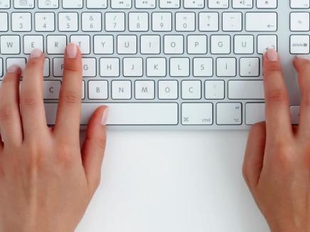 hands typing on a keyboard