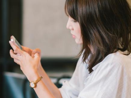 Woman types on phone