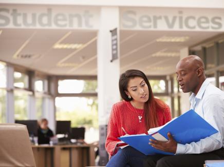 Two individuals reviewing paperwork